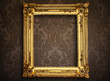 Empty golden painting frame on vintage wallpaper Empty golden painting frame on vintage wallpaper