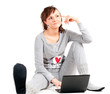Young woman in pajamas with laptop Young woman in pajamas with laptop