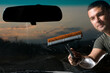 Photo: Adult man washing dirty windshield of his car. Adult man washing dirty windshield of his car.