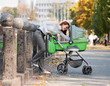 Young mother carrying baby in autumn park