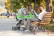 Happy young mother with baby in buggy