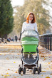 Happy young mother with baby in buggy