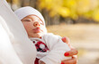 Sleeping little girl on mother's hands