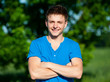 cheerful young man in blue t-shirt
