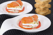 Salmon rolls decorated with cheese and tomato