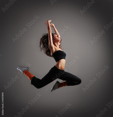 Photo: A young brunette woman cought in a jump A young brunette woman cought in a jump
