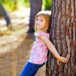 blond kid girl on autumn tree trunk blond kid girl on autumn tree trunk