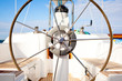Photo: A steering wheel on a boat with empty seats. A steering wheel on a boat with empty seats.