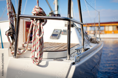 Photo: Luxurious modern white yacht moored in port or harbor. Luxurious modern white yacht moored in port or harbor.