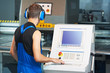 worker operating cnc punch press