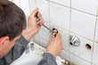 Plumber fixing pipeline with tool in hands Plumber fixing pipeline with tool in hands