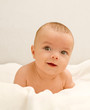 Little baby lying on the white blanket