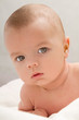 Little baby lying on the white blanket - closeup