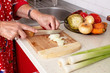 Senior woman's hands cutting vegetables