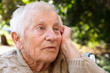 Foto: Pensive senior lady in wheelchair outside Pensive senior lady in wheelchair outside
