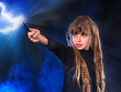 Girl in witch's hat with magic wand.