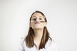 young businesswoman holding pen with his nose