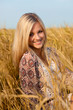 woman sitting on wheat field