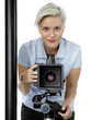 Pretty young photographer with her camera  at a photo shoot