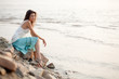 woman sitting on stone