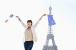 Photo: Woman holding a European Union flag and a French flag with the Eiffel Tower in the background, Paris, Ile-de-France, France Woman holding a European Union flag and a French flag with the Eiffel Tower in the background, Paris, Ile-de-France, France