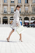 Woman walking on a street, Paris, Ile-de-France, France
