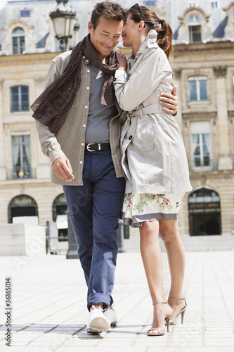 Photo: Couple walking on a street, Paris, Ile-de-France, France Couple walking on a street, Paris, Ile-de-France, France