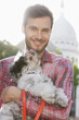 Man carrying a puppy, Paris, Ile-de-France, France