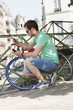 Photo: Man locking his bicycle, Paris, Ile-de-France, France Man locking his bicycle, Paris, Ile-de-France, France