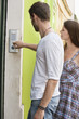 Man ringing a doorbell, Paris, Ile-de-France, France