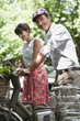 Photo: Couple riding bicycles and smiling, Paris, Ile-de-France, France Couple riding bicycles and smiling, Paris, Ile-de-France, France