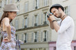 Photo: Man taking a picture of a woman standing with her hand on her hip, Paris, Ile-de-France, France Man taking a picture of a woman standing with her hand on her hip, Paris, Ile-de-France, France