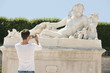 Photo: Man taking a picture of a sculpture in a garden, Jardin des Tuileries, Paris, Ile-de-France, France Man taking a picture of a sculpture in a garden, Jardin des Tuileries, Paris, Ile-de-France, France