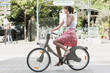 Photo: Woman riding a bicycle and talking on a mobile phone, Paris, Ile-de-France, France Woman riding a bicycle and talking on a mobile phone, Paris, Ile-de-France, France