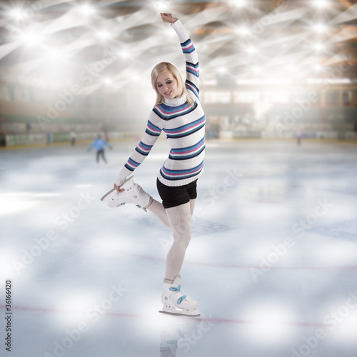 Photo: young beautiful woman ice skating young beautiful woman ice skating