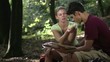couple looking at map and eating snack after trekking