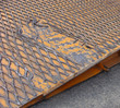 Photo: detail damaged orange ramp truck trailer for car transport detail damaged orange ramp truck trailer for car transport