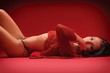 Photo: beautiful young woman on a red background beautiful young woman on a red background