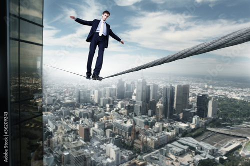 Photo: Business man balancing on the rope Business man balancing on the rope