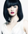 beautiful girl with perfect skin, red lipstick and black hair