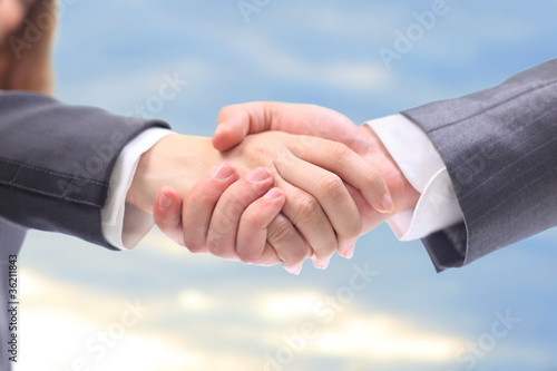 Photo: handshake in the blue sky handshake in the blue sky
