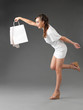 fashionable young woman holding shoppping bag, tumbling