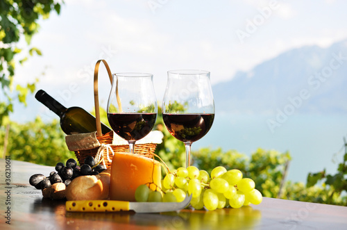 Photo: Red wine, grapes and cheese. Lavaux region, Switzerland Red wine, grapes and cheese. Lavaux region, Switzerland