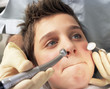 Boy refusing to open mouth for dentist Boy refusing to open mouth for dentist