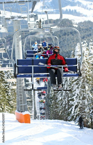 Photo: Skiers in chairlift Skiers in chairlift