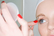 Woman plucking eyebrow Woman plucking eyebrow