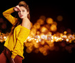 fashion model in autumn/winter clothes posing in the studio