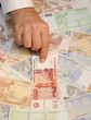 Man`s hand pointing to rouble banknote Man`s hand pointing to rouble banknote