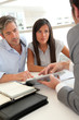 Real-estate agent showing house plans on electronic tablet Real-estate agent showing house plans on electronic tablet