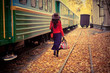 beautiful young woman near a train
